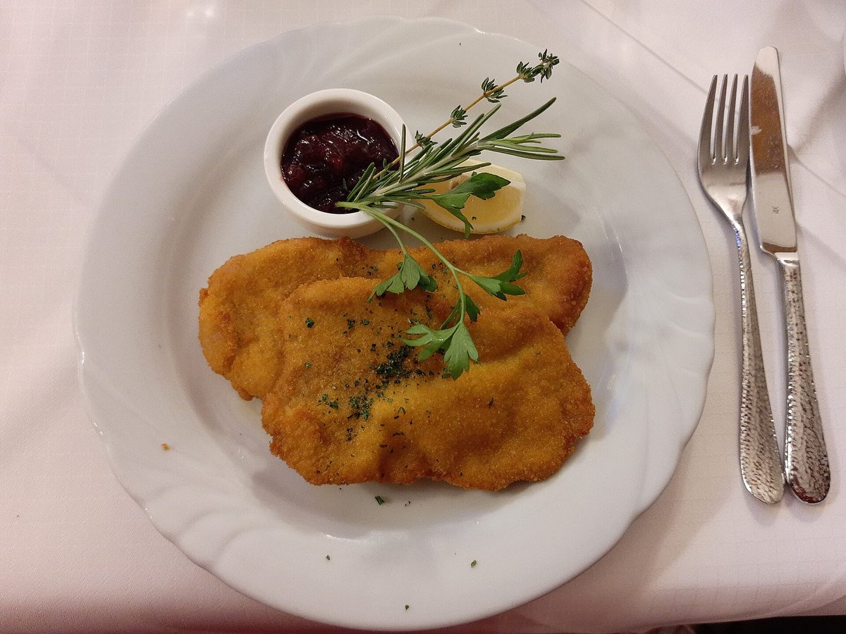 A classic Wiener Schnitzel with lemon, parsley and cranberry, Austria's national dish
