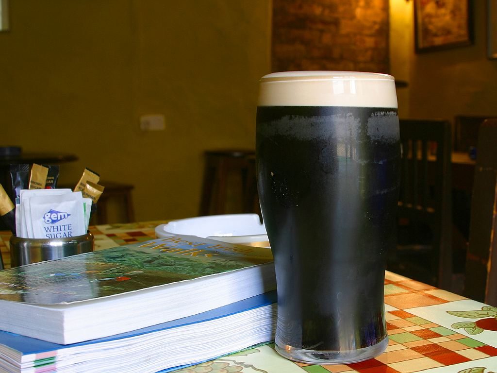 A freshly poured pint of Guinness in a traditional Irish pub