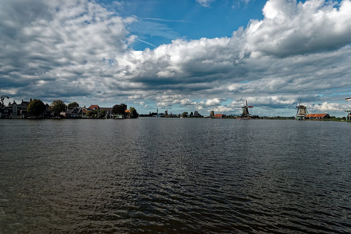 Historic green windmills along the river at Zaanse Schans, Netherlands