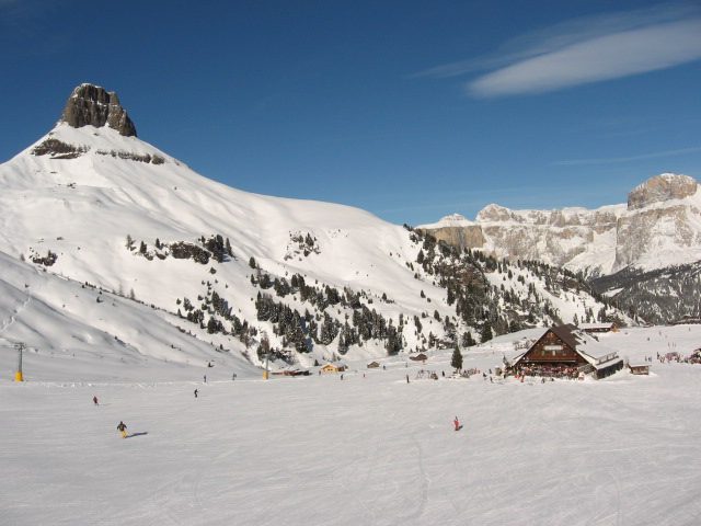Ski pistes winding beneath the jagged peaks of the Italian Dolomites