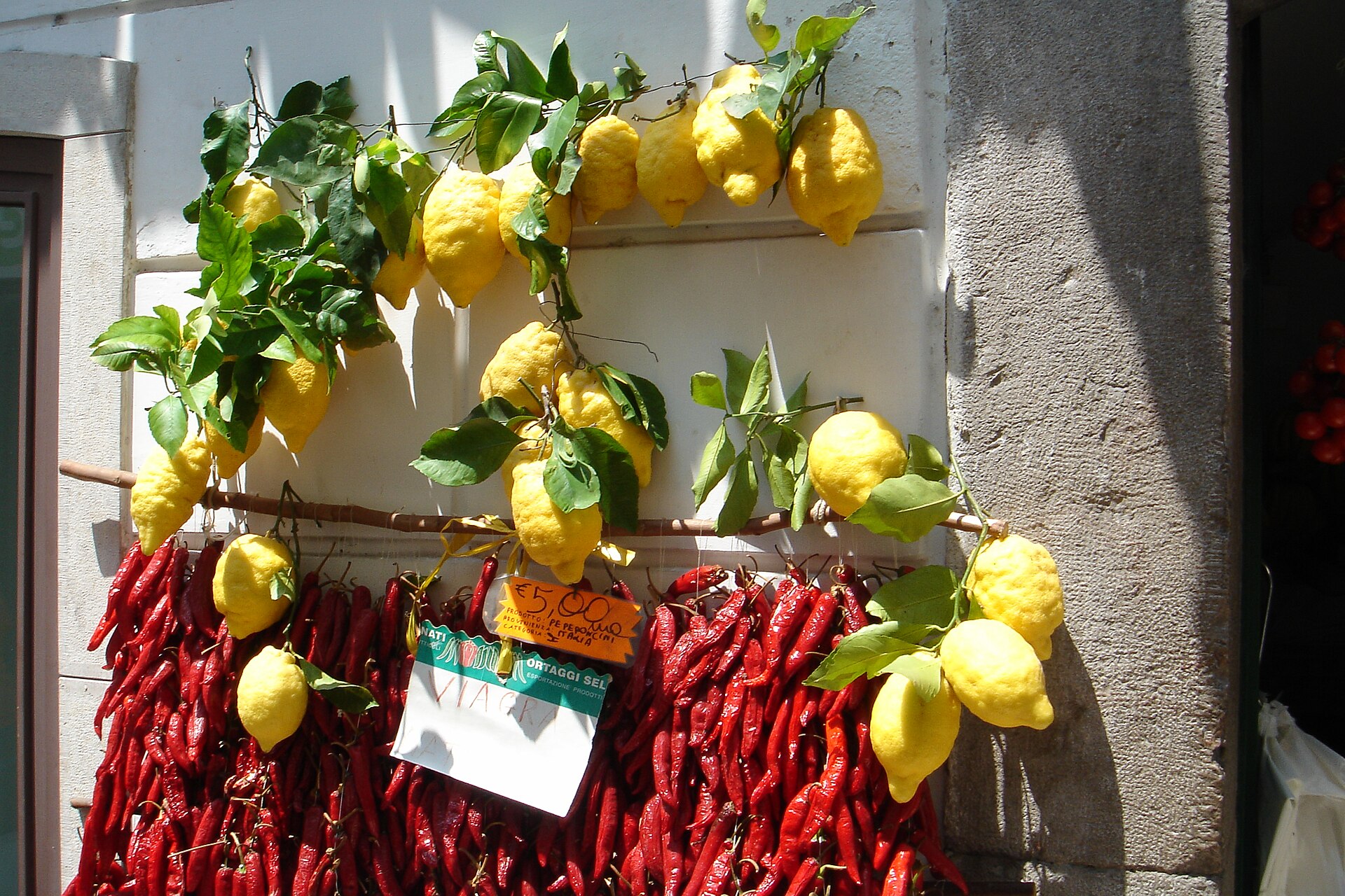 Amalfi lemons and dried peppers hanging outside a shop in Amalfi