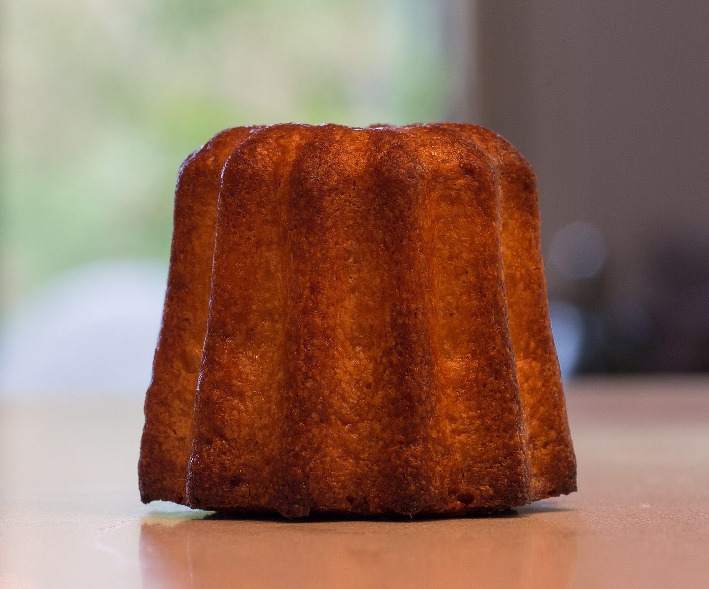 A canele de Bordeaux with its dark caramelised crust