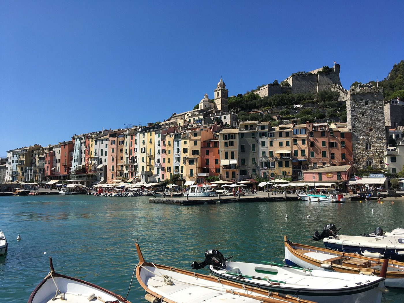 The tall painted houses along the Portovenere waterfront below the Doria Castle