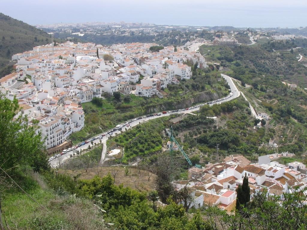 The white houses of Frigiliana stacked on the hillside above the coast near Nerja