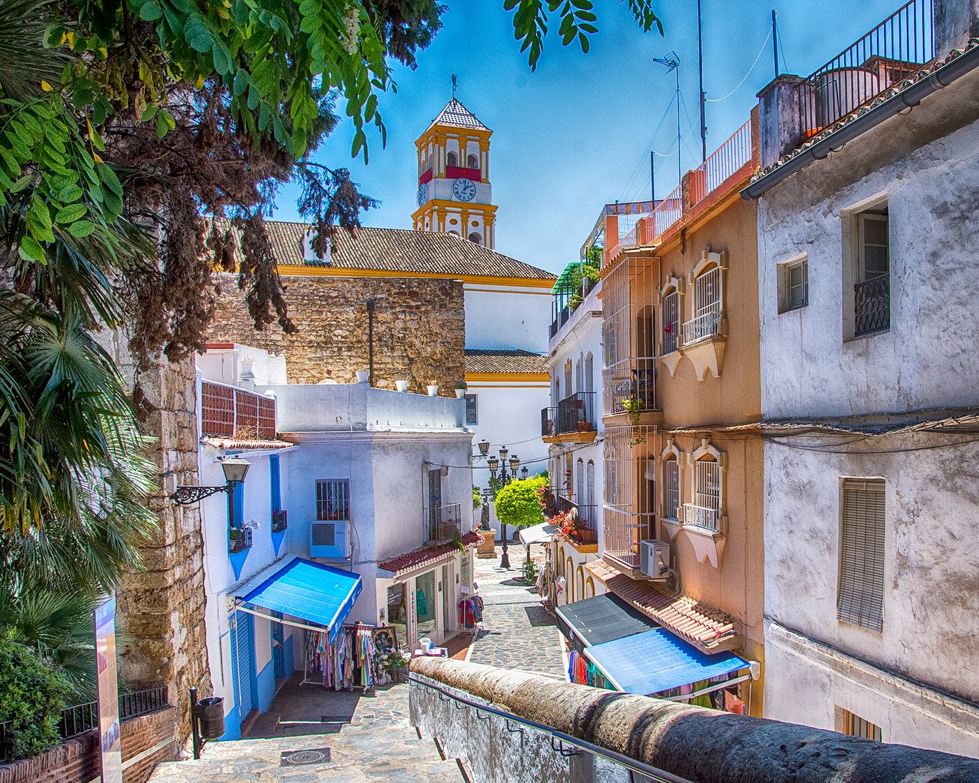 A whitewashed lane in the old town of Marbella below the church clock tower