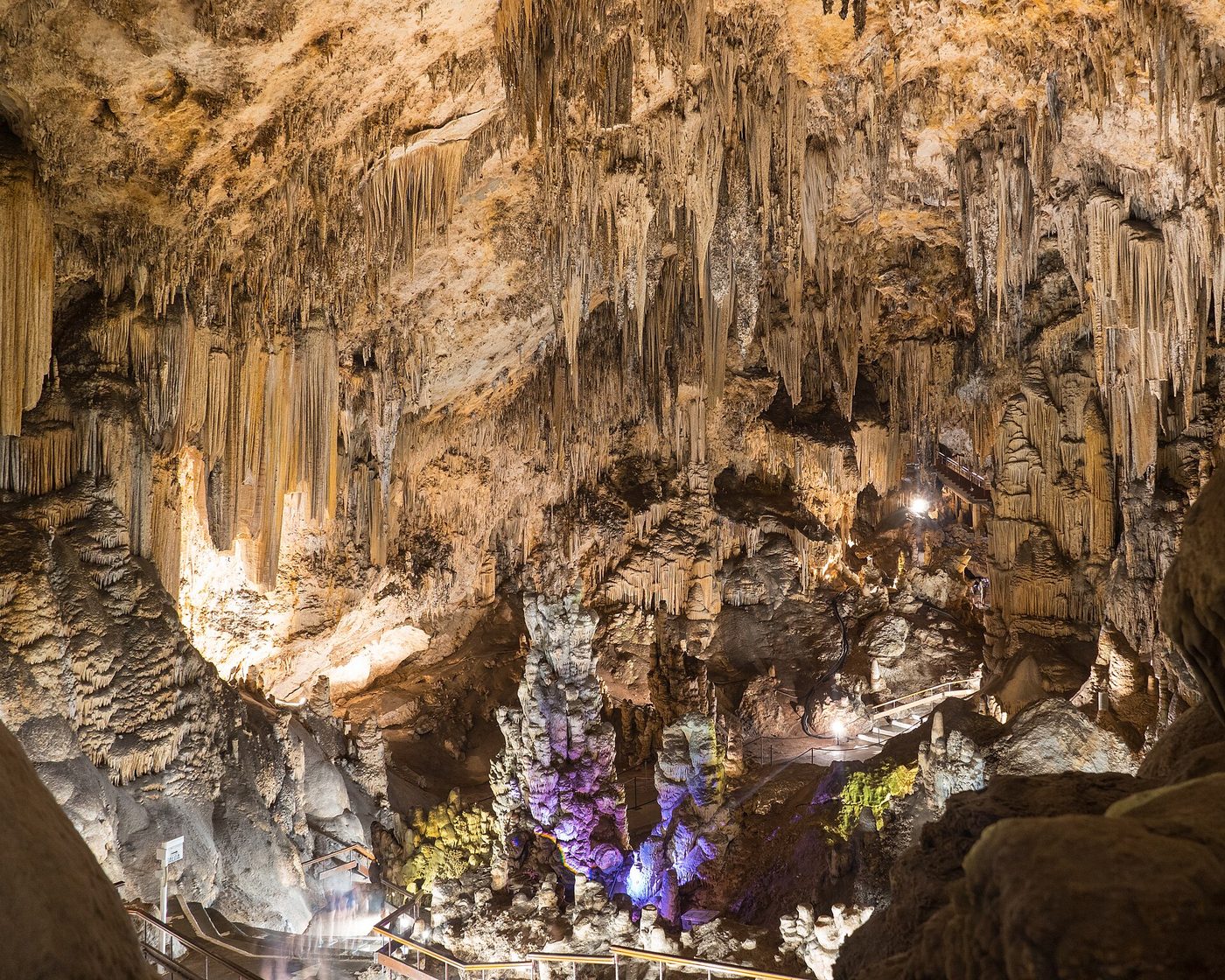 Floodlit stalactite columns inside the Cueva de Nerja