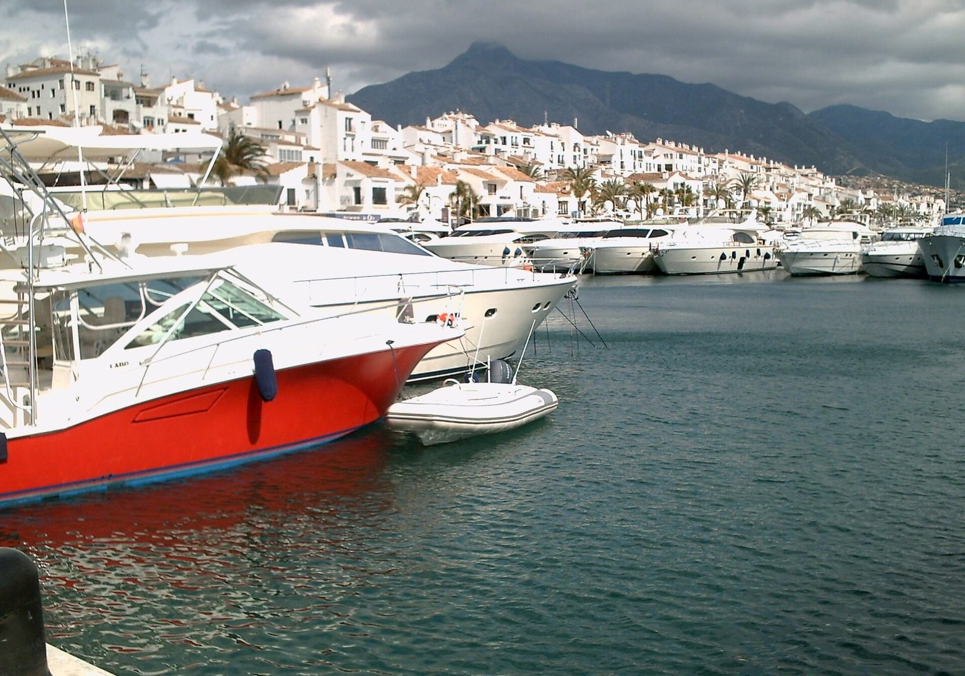 Motor yachts moored at Puerto Banus marina with La Concha mountain behind