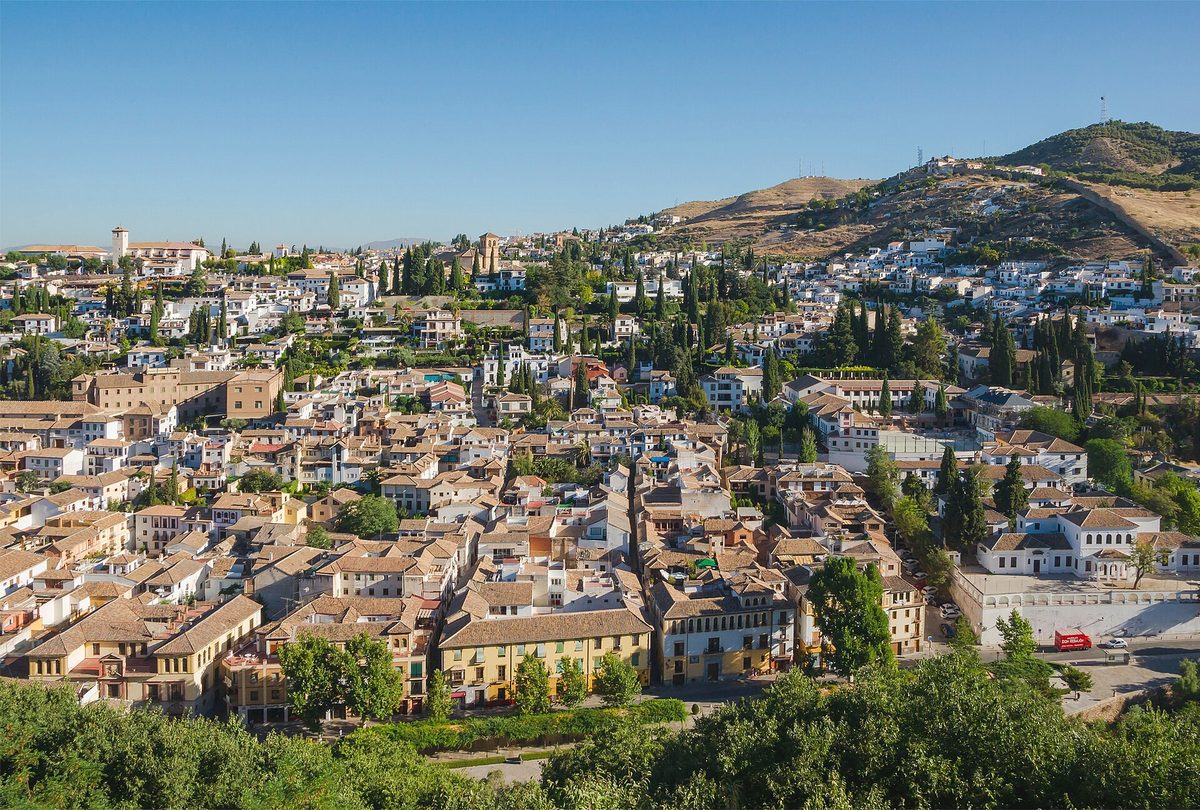 The rooftops of Granada rising towards the Albayzin and the Sacromonte hills