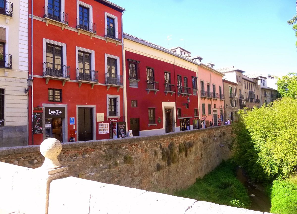 Red-painted houses along the Carrera del Darro above the river in Granada