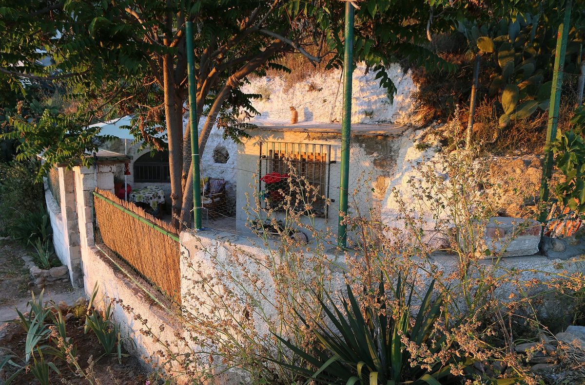 A whitewashed cave house cut into the hillside at Sacromonte, Granada