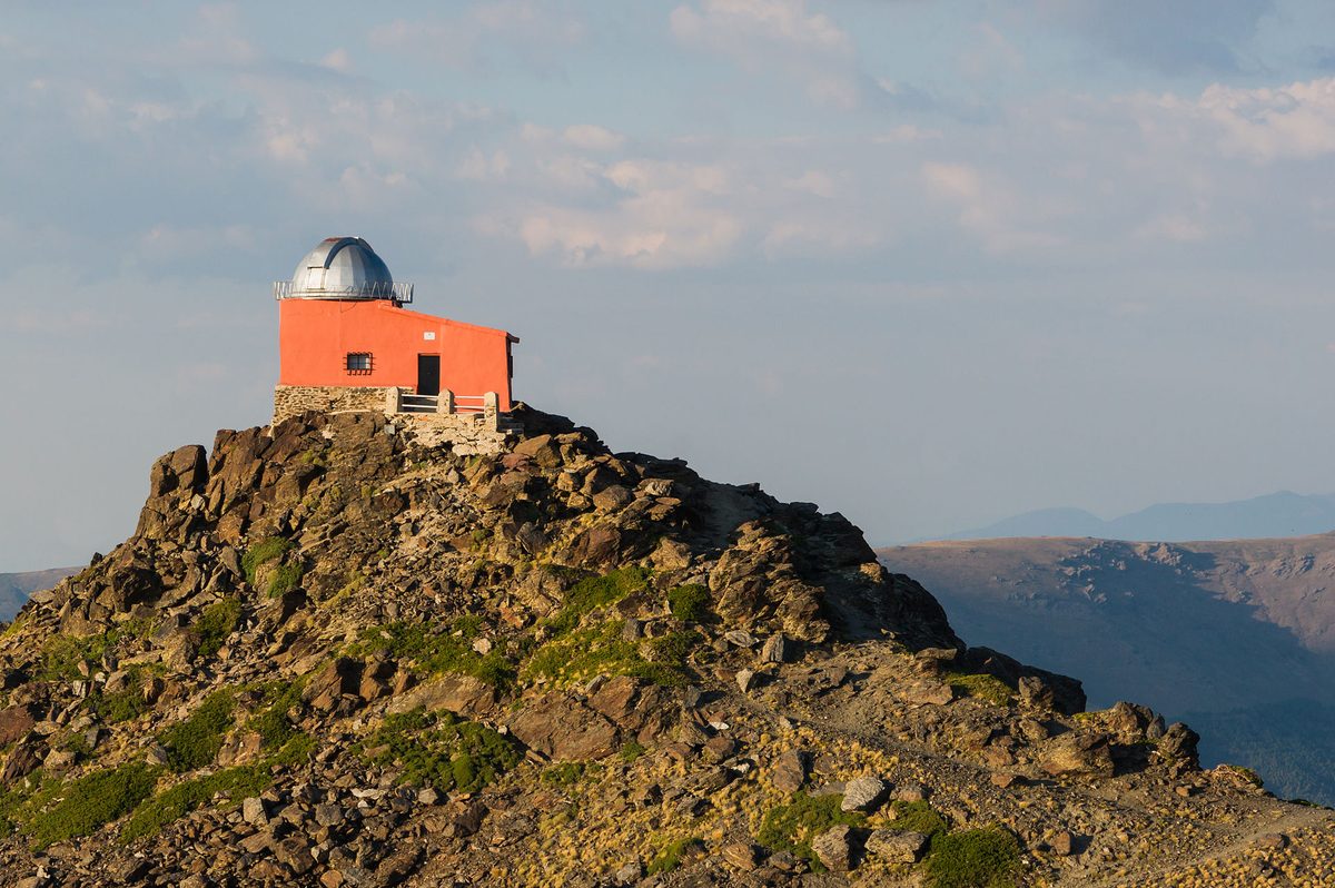 The restored Mojon del Trigo observatory on a rocky ridge in the Sierra Nevada above Granada