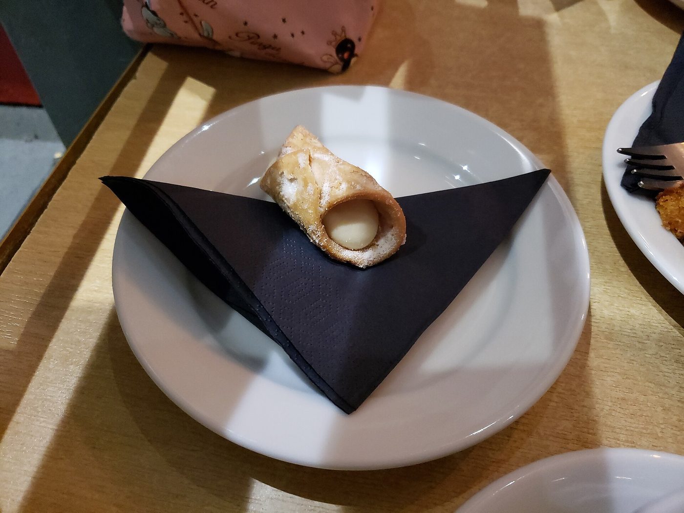 A cannolo filled to order, the Sicilian pastry that should never be filled in advance