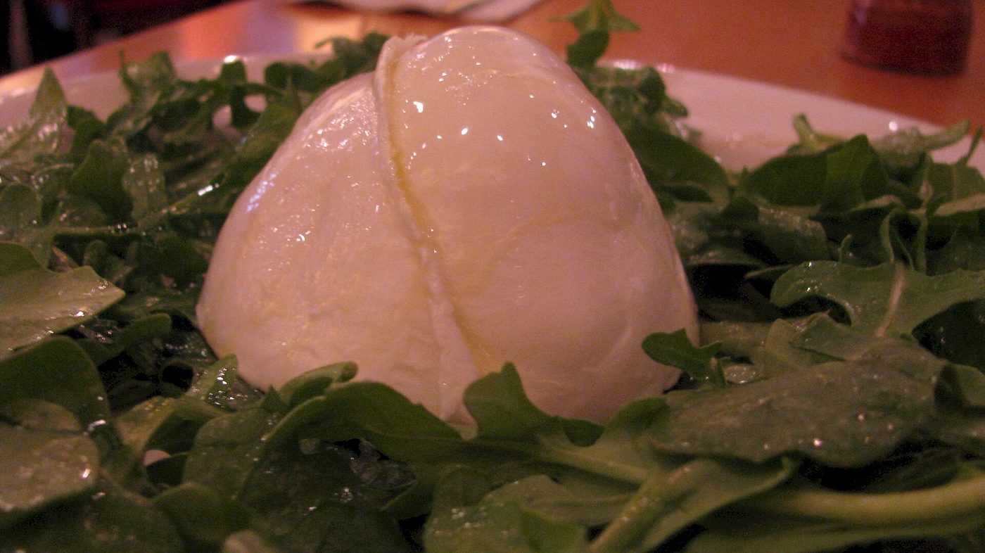 A ball of mozzarella di bufala campana served on rocket