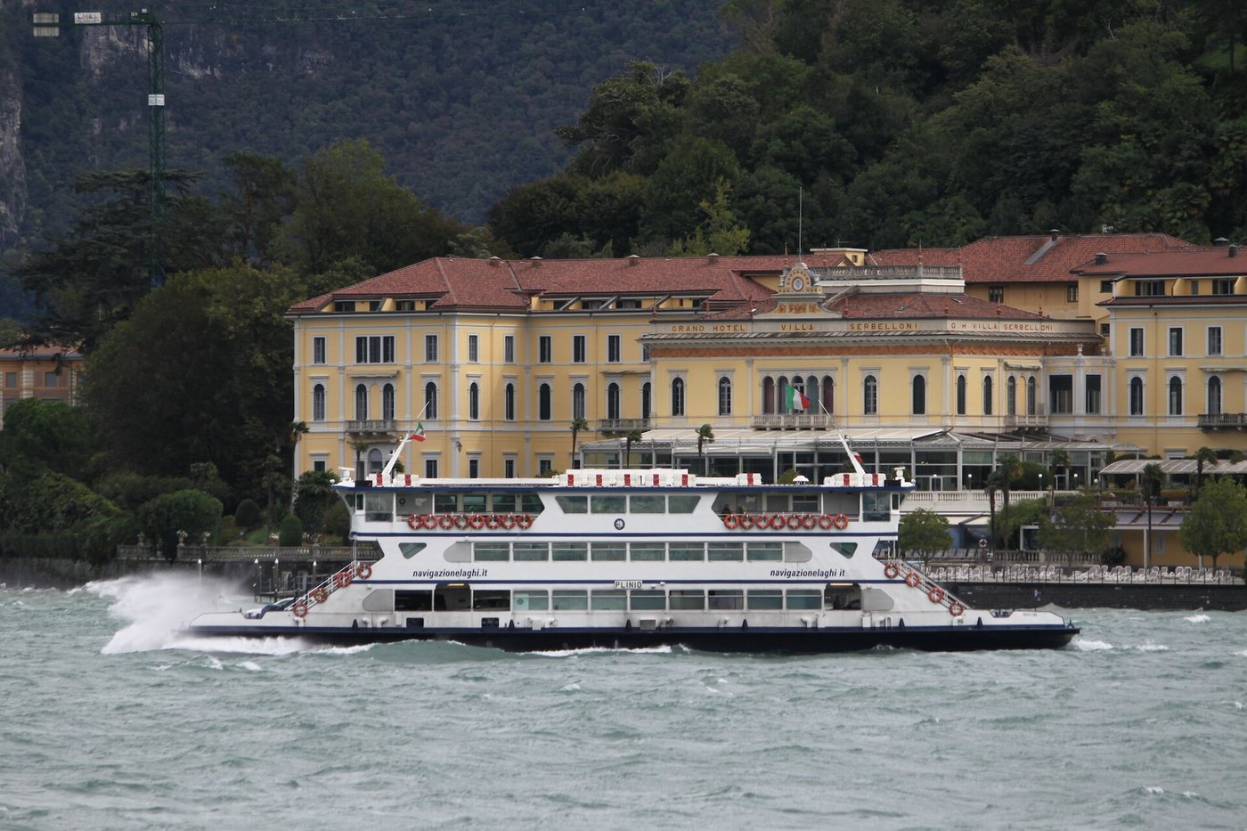 A car ferry pulling away from the Bellagio waterfront on Lake Como