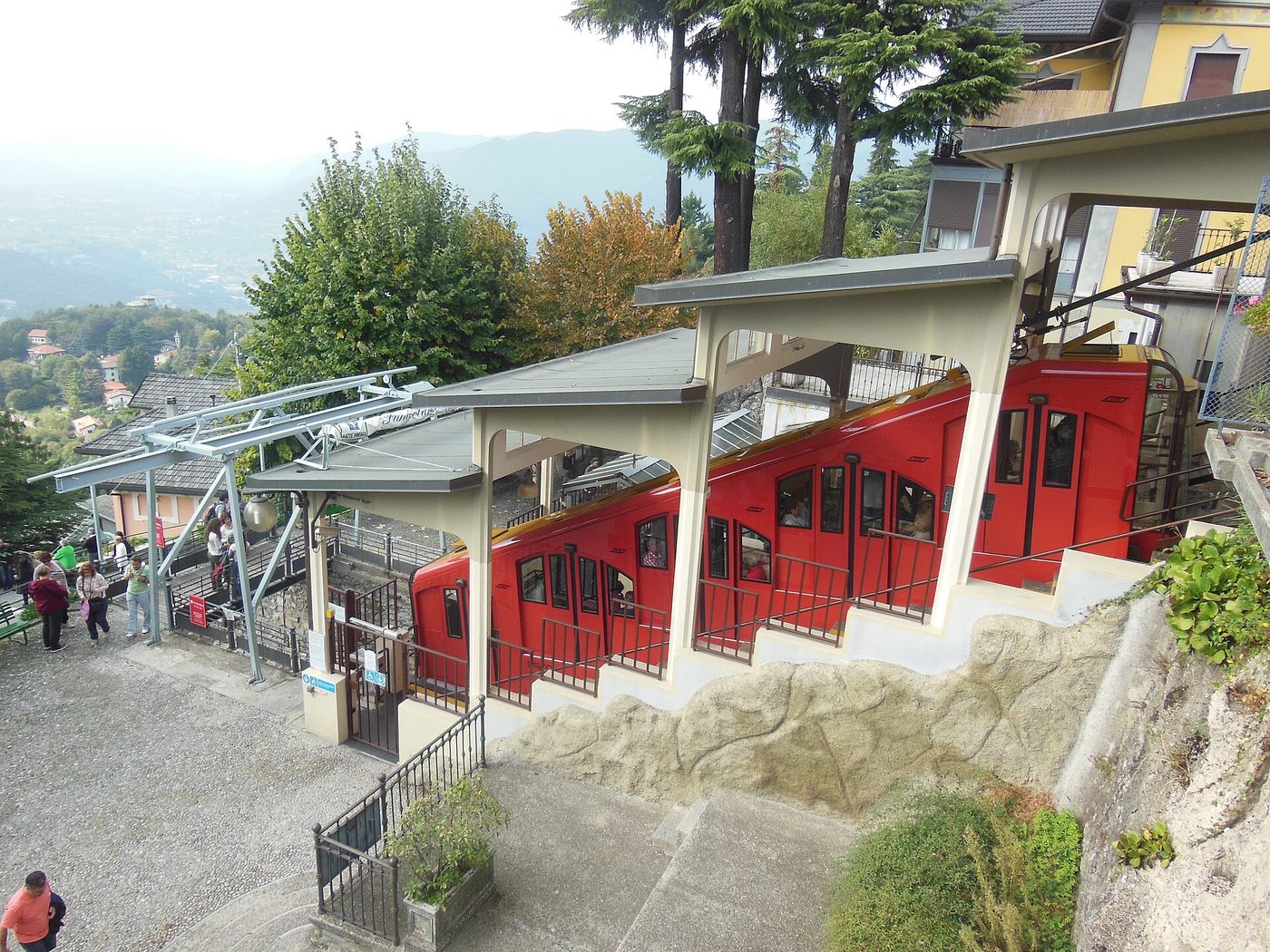 The red cars of the Como to Brunate funicular at the upper station