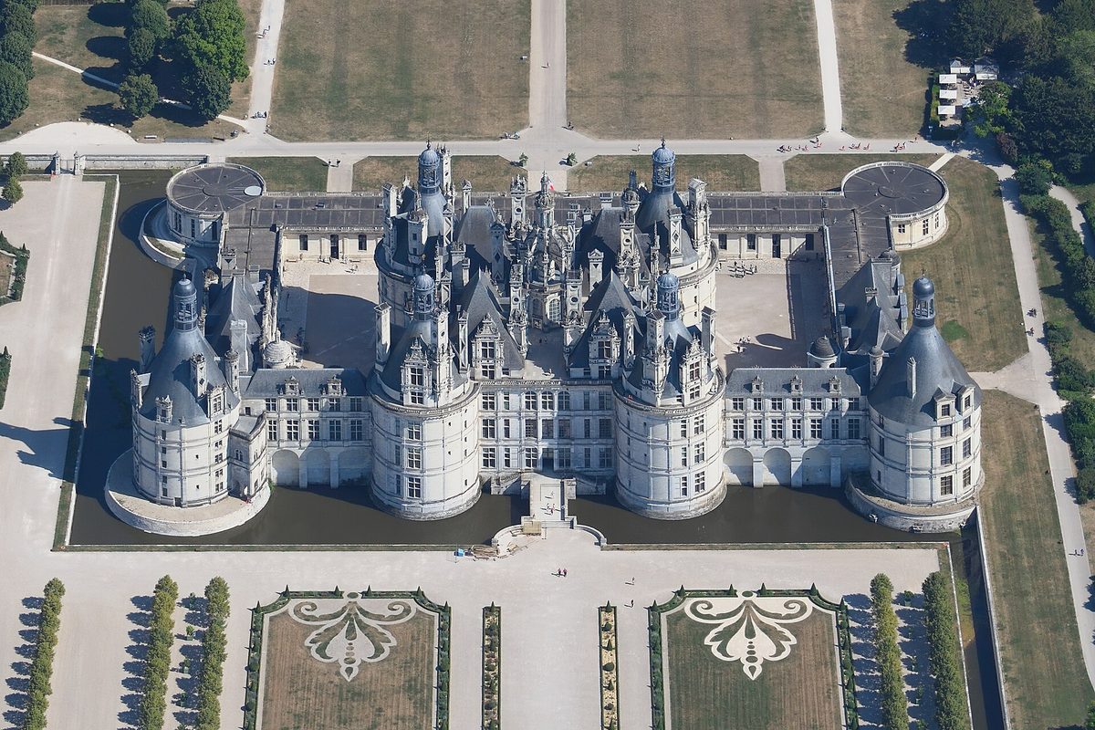 Loire Valley travel: an aerial view of the Château de Chambord, its moat and formal gardens