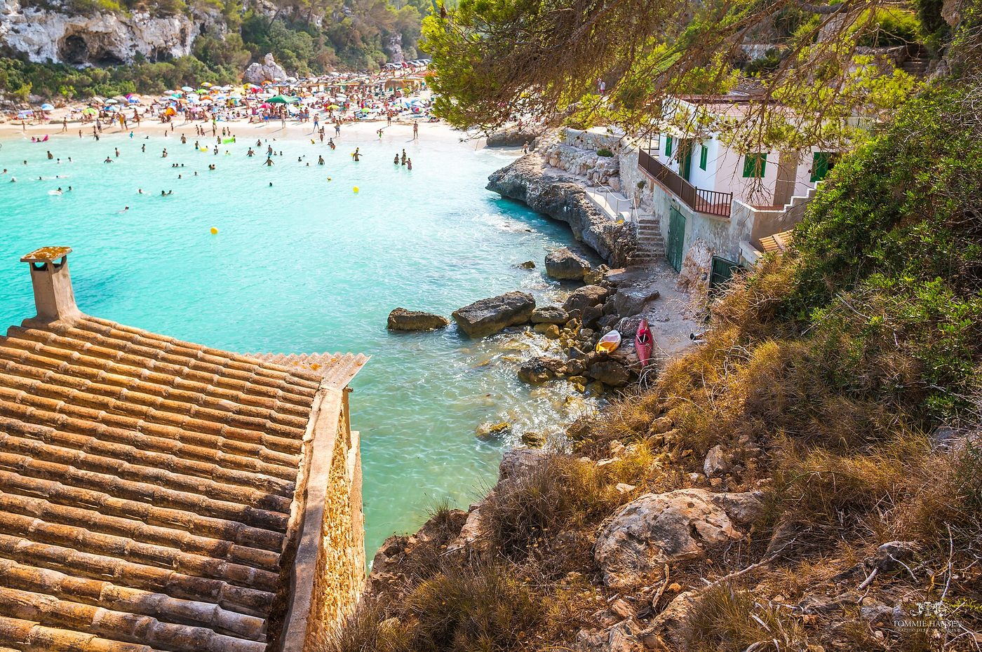 Turquoise water and old beach huts at Cala Llombards on the south-east coast of Mallorca