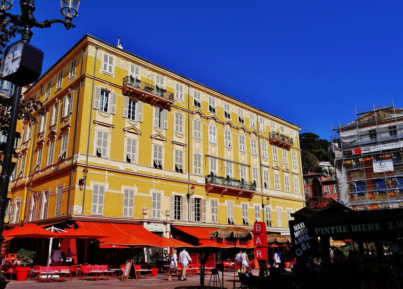 Cafe awnings and market stalls along the Cours Saleya in Nice
