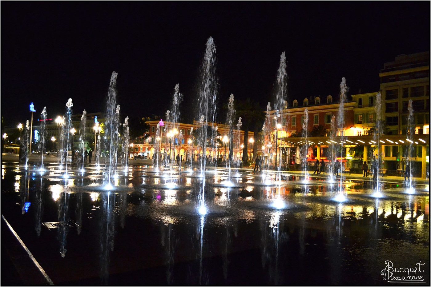 The illuminated fountains of Place Massena in Nice after dark