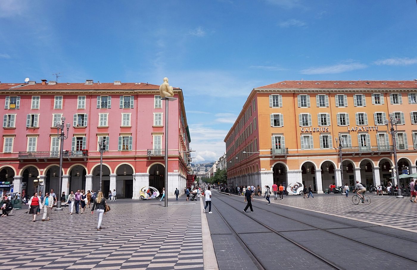 The ochre arcades of Place Massena in Nice, where the tram lines cross the square