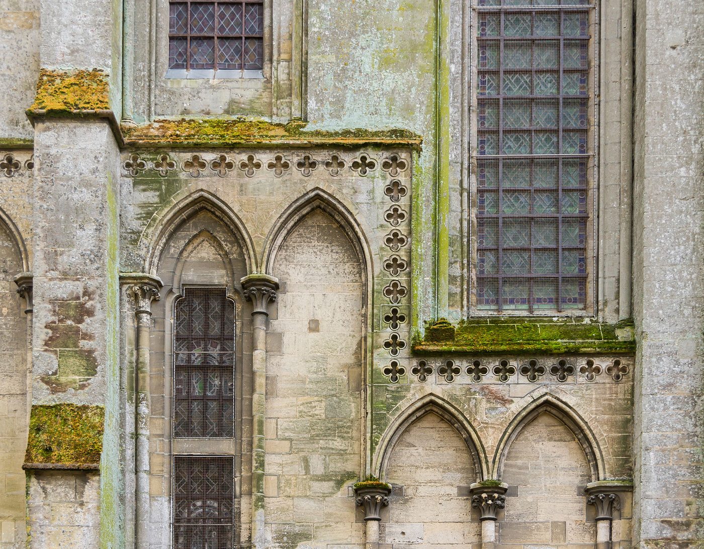 Carved Gothic tracery and stained glass on the flank of Bayeux Cathedral