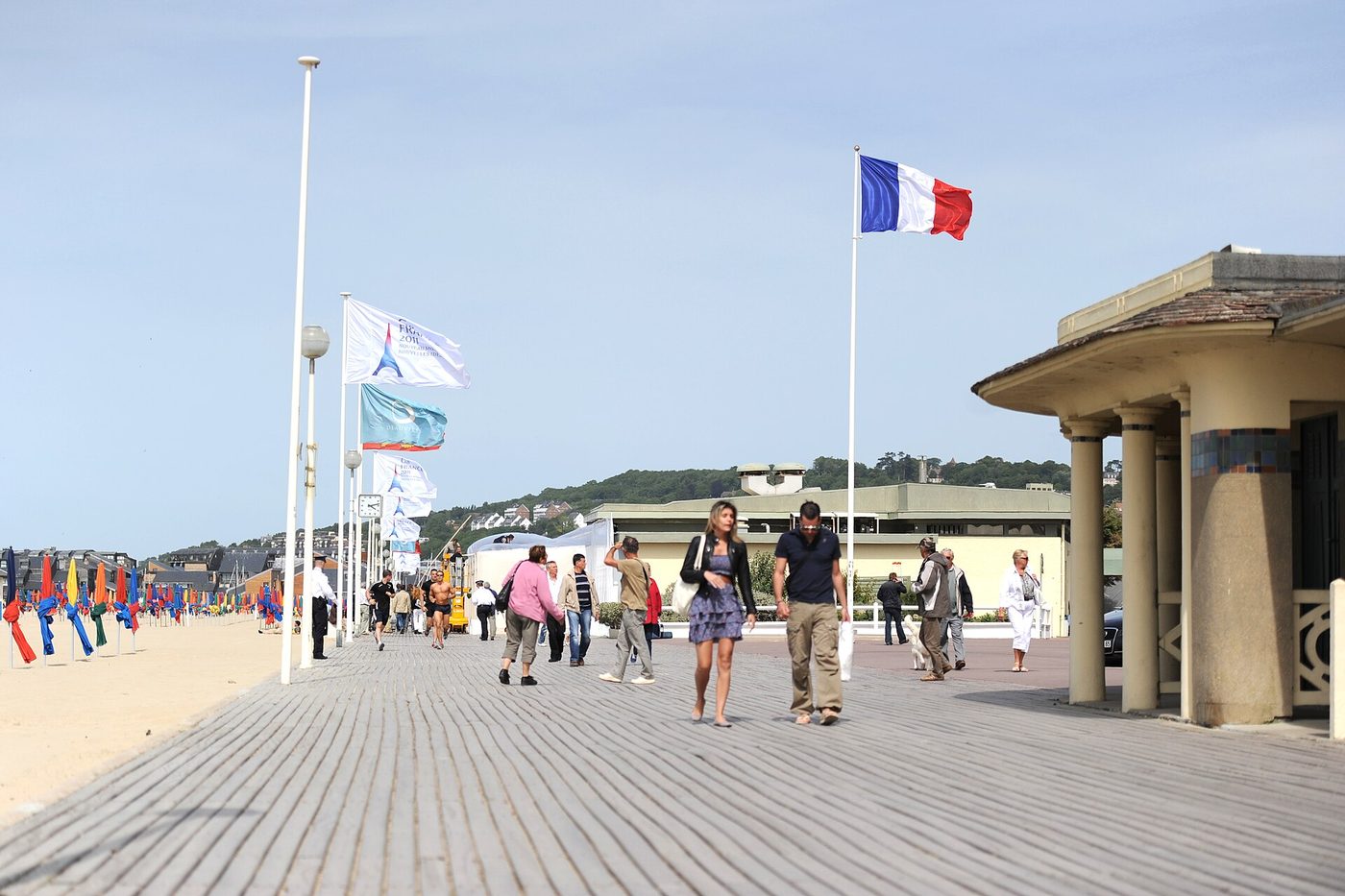 Coloured beach parasols beside Les Planches boardwalk at Deauville