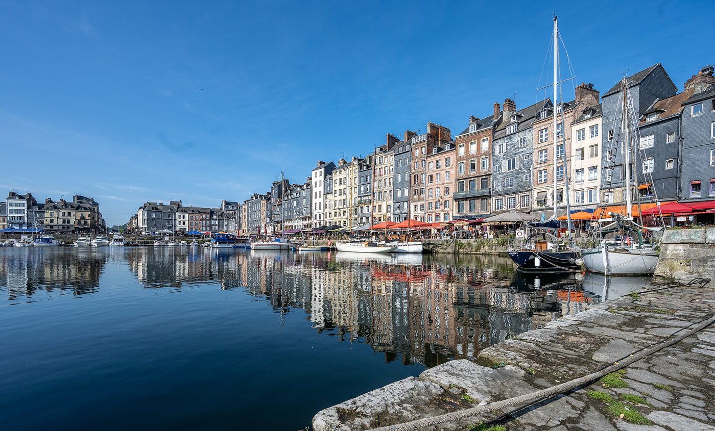 Tall slate-fronted houses reflected in the Vieux Bassin at Honfleur
