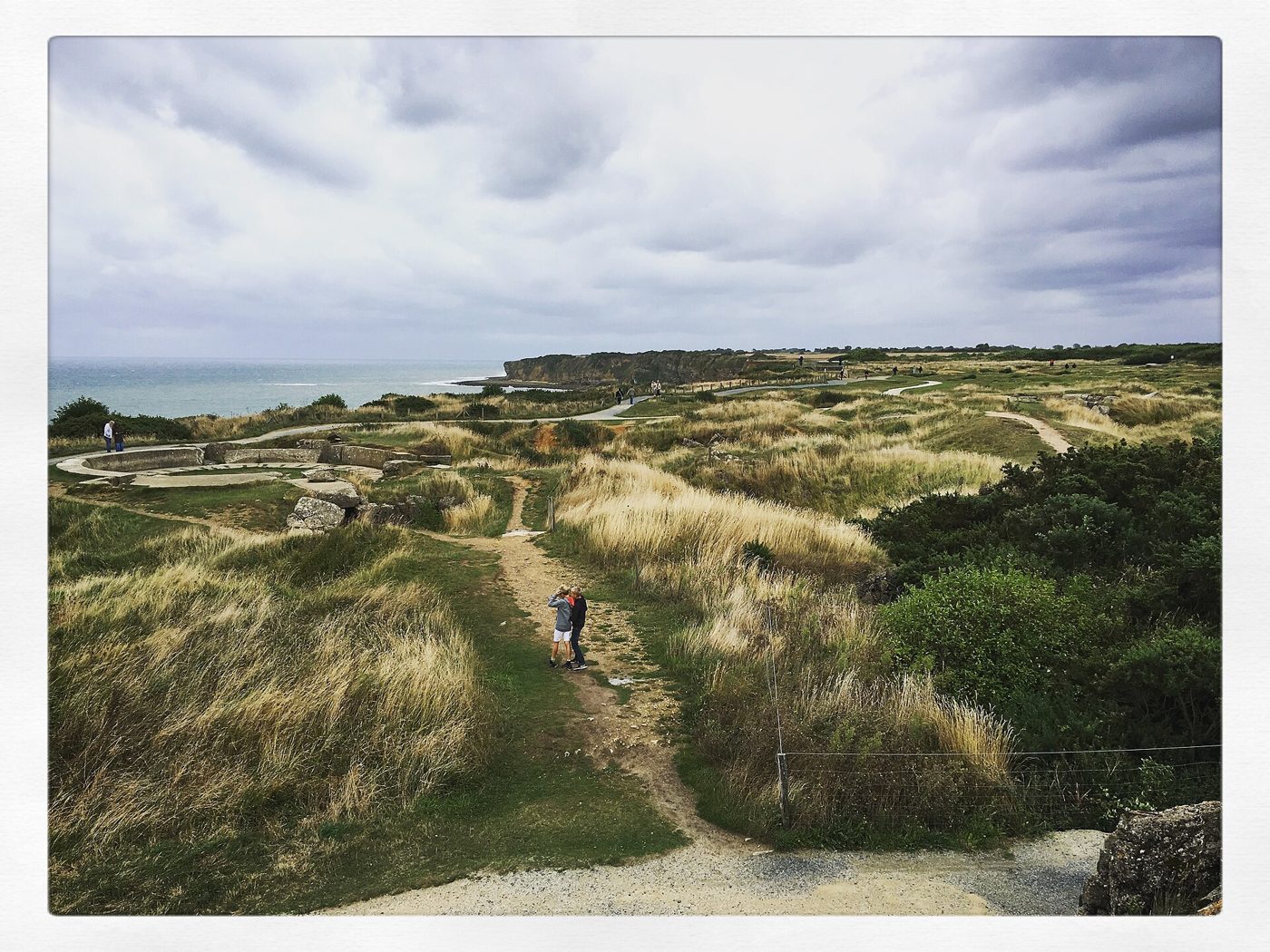 Shell craters and broken concrete across the clifftop at Pointe du Hoc