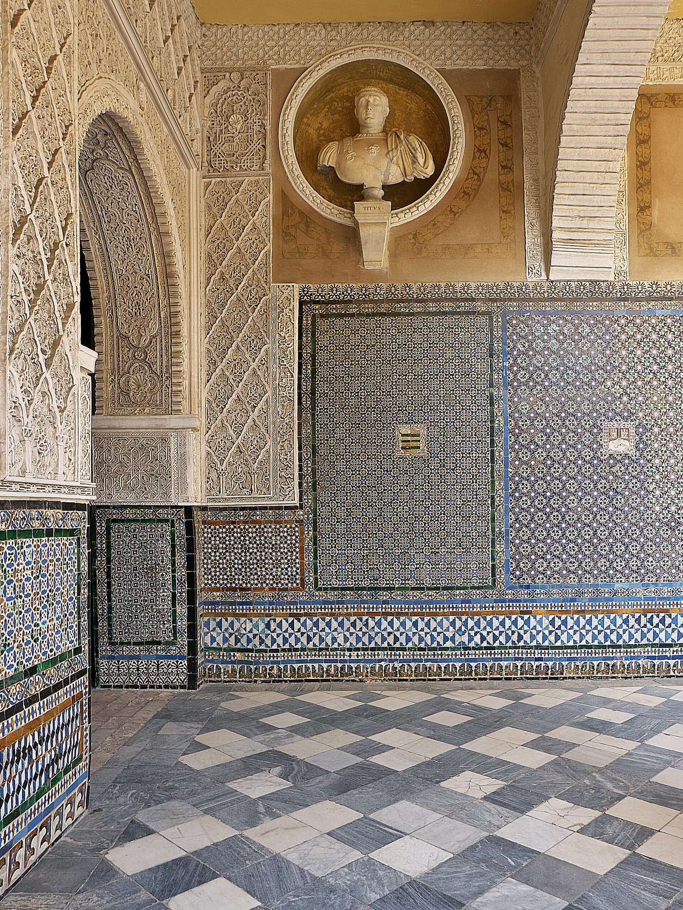 Azulejo tilework and a marble bust inside the Casa de Pilatos in Seville