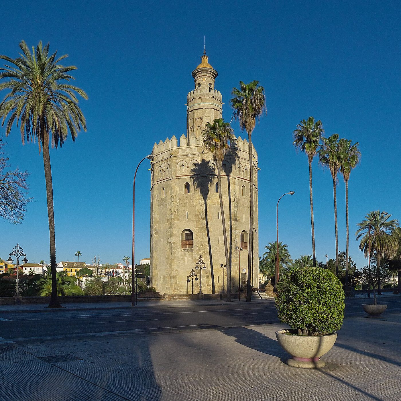 The Torre del Oro standing among palms beside the Guadalquivir in Seville