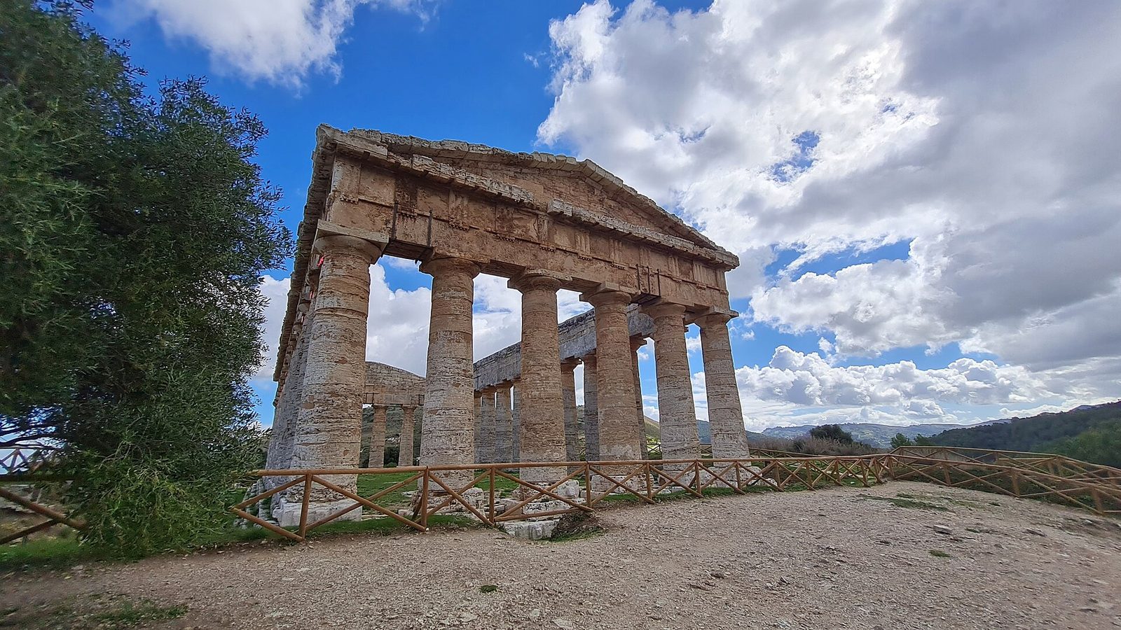 The unfinished Doric temple at Segesta standing alone in its valley in western Sicily