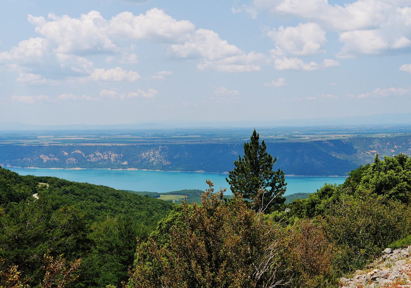 The green water of the Verdon Gorge running between limestone cliffs in Provence