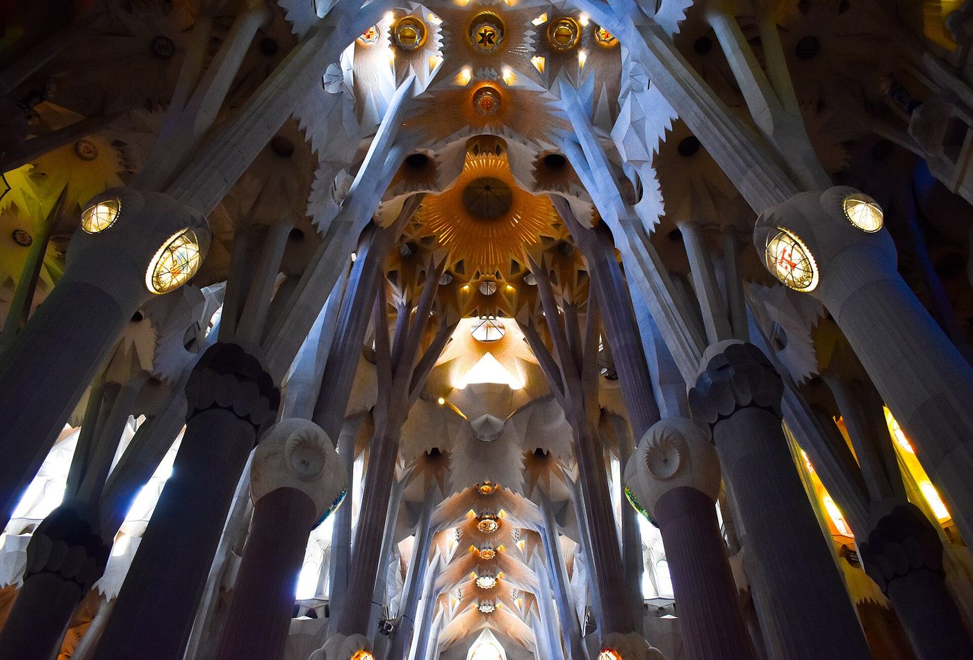 Light through stained glass on the tree-like columns inside the Sagrada Familia, Barcelona