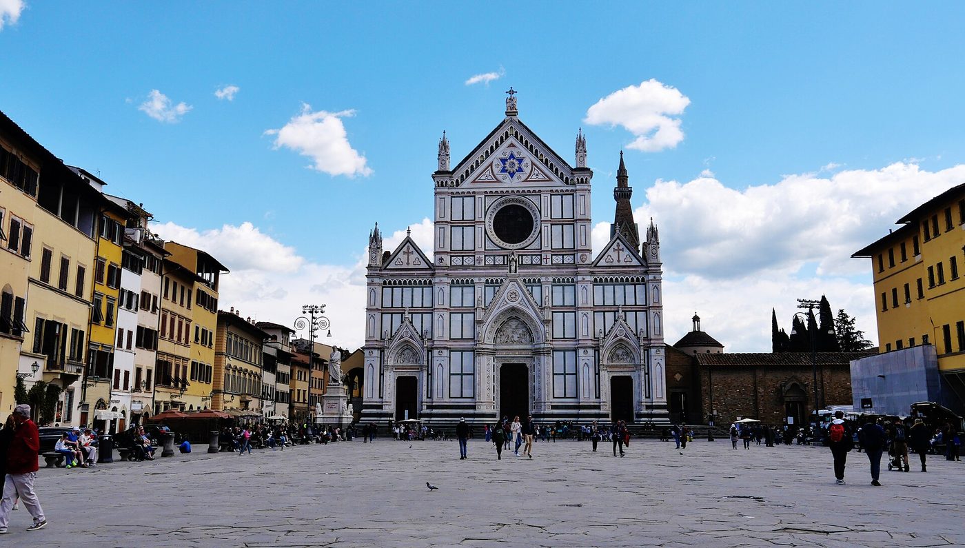 The marble facade of the Basilica di Santa Croce across its wide piazza in Florence