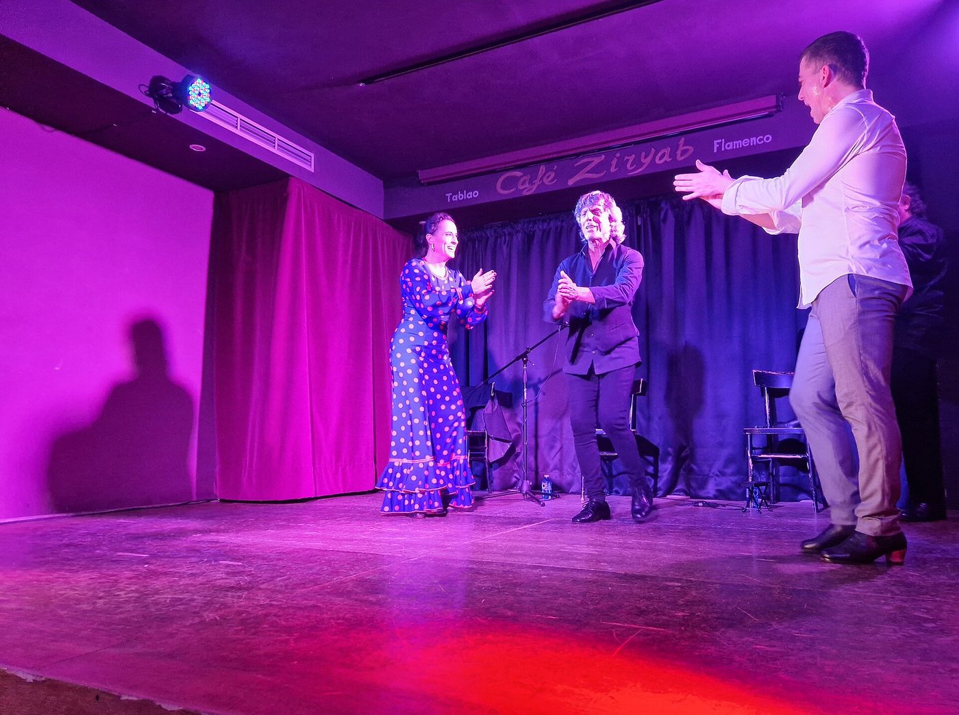 Dancers clapping during a flamenco performance at a tablao