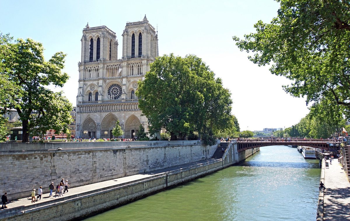 The west facade and towers of Notre-Dame de Paris seen from the quays of the Seine