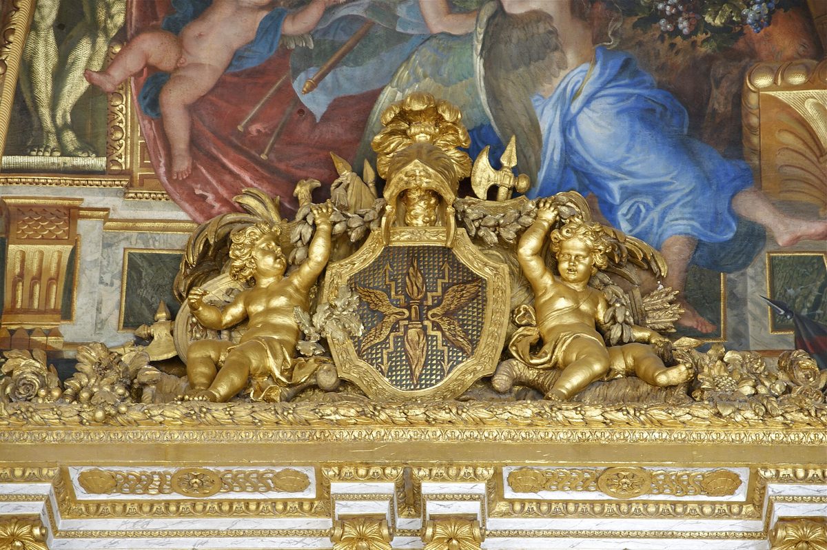 Gilded cherubs and painted ceiling detail inside the Palace of Versailles